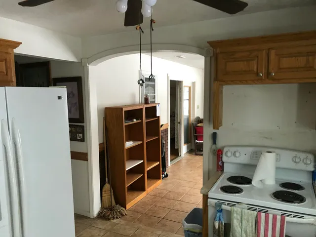 a kitchen with a refrigerator and cabinets