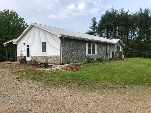 a view of a house with yard and a garden