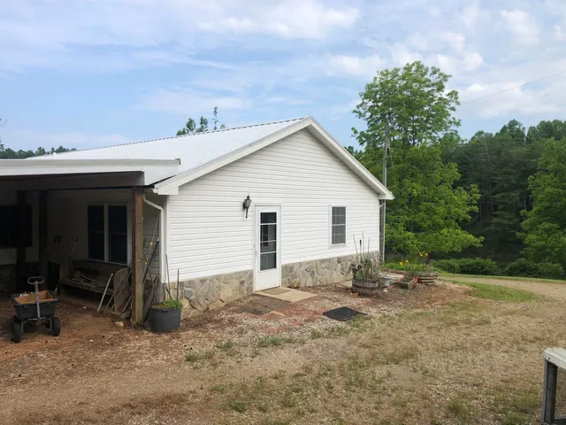 a view of a house with a yard and potted plants