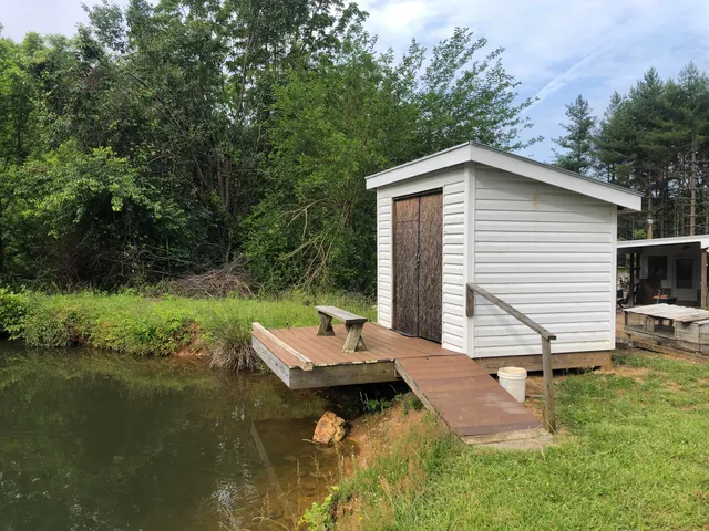 a backyard of a house with a yard and outdoor seating