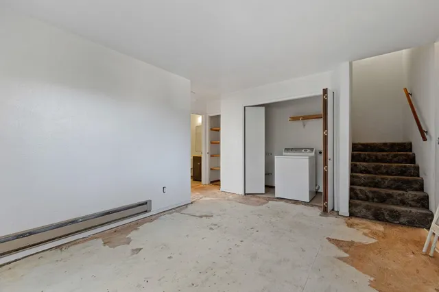 a view of an empty room with stairs and ventilation