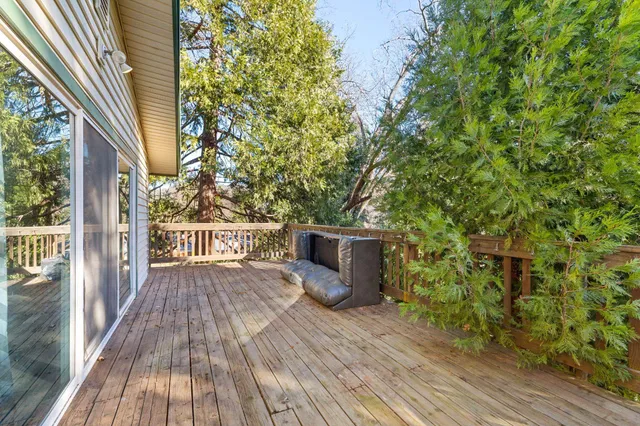 a view of a balcony with wooden floor and fence