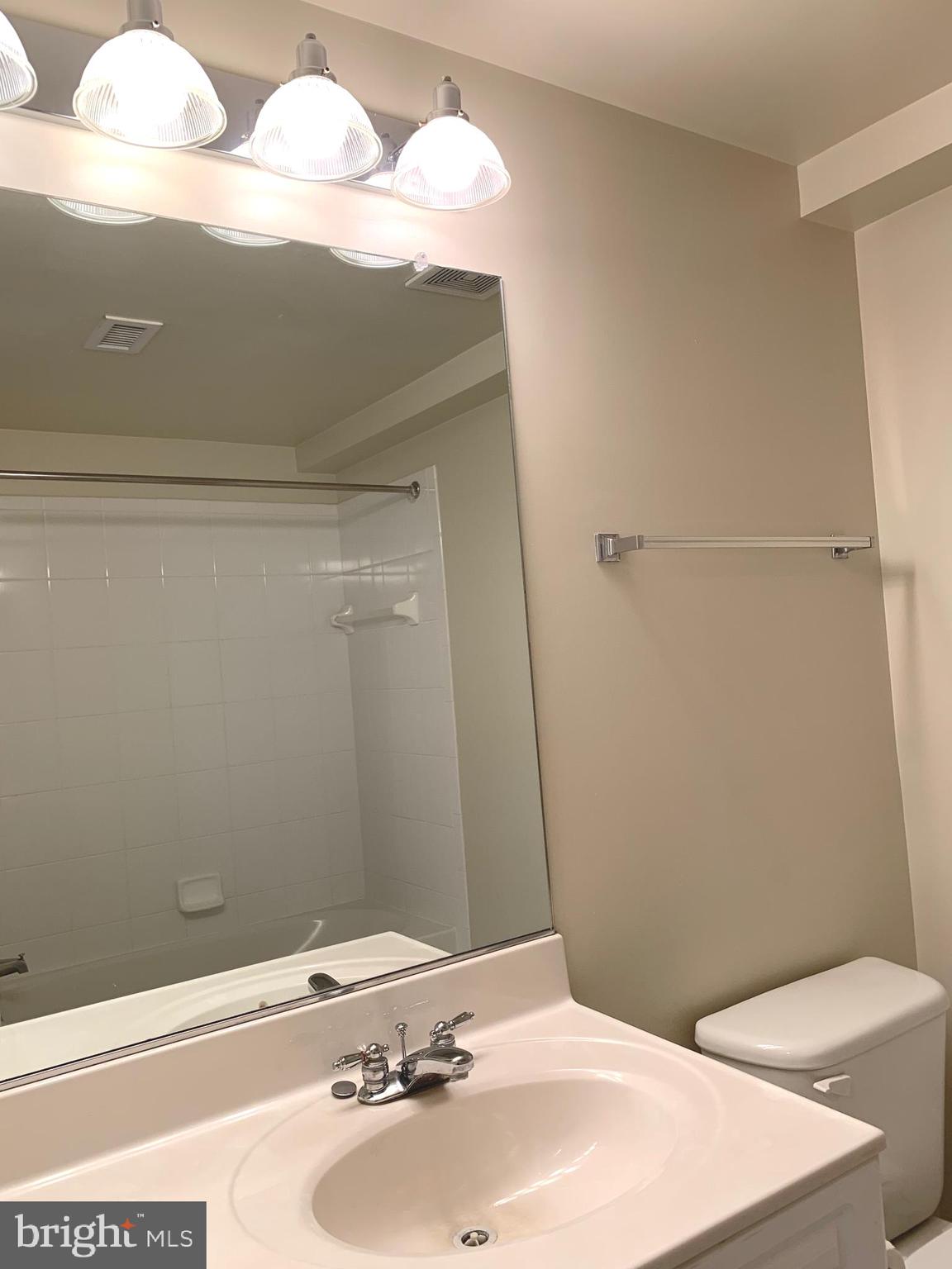 2726 Gallows Road, Unit 1502 Vienna, VA 22180 - Photo 7 of 46 Bathroom offers a tub shower and bright lighting