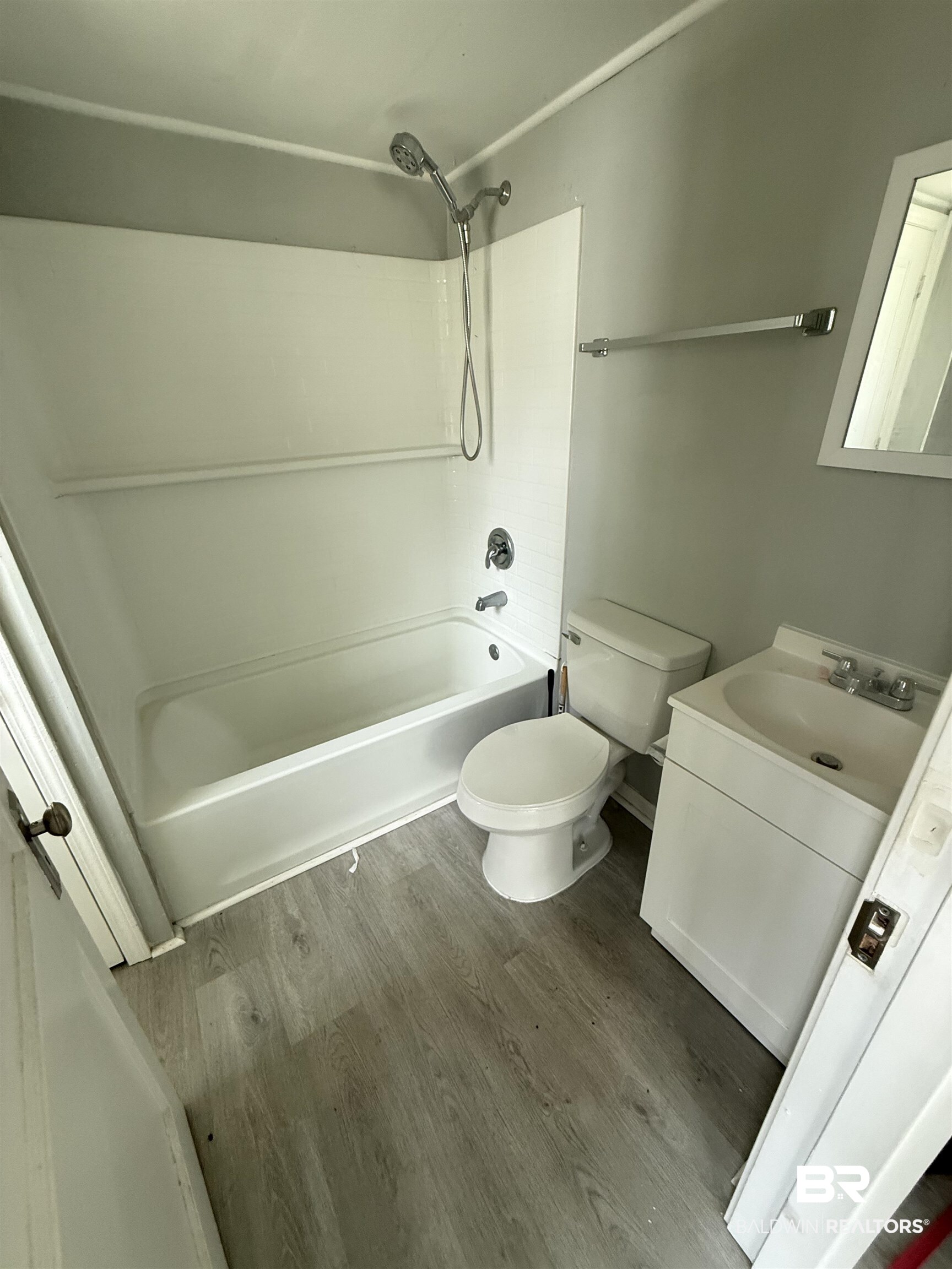 1848 Canal Street Mobile, AL 36606 - Photo 9 of 11 Bathroom with vanity, wood finished floors, and shower / bathtub combination