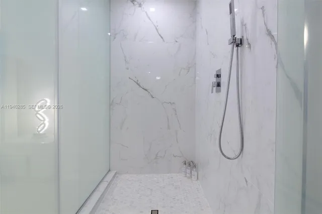 a bathroom with a glass shower door