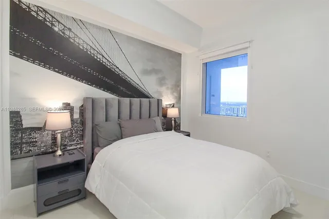 a large bed sitting in a bathroom next to a window