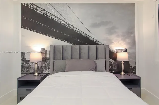 a bedroom with a bed and a lamp