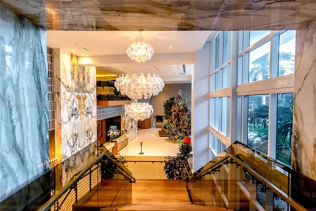 a view of a dining room with furniture a chandelier and wooden floor