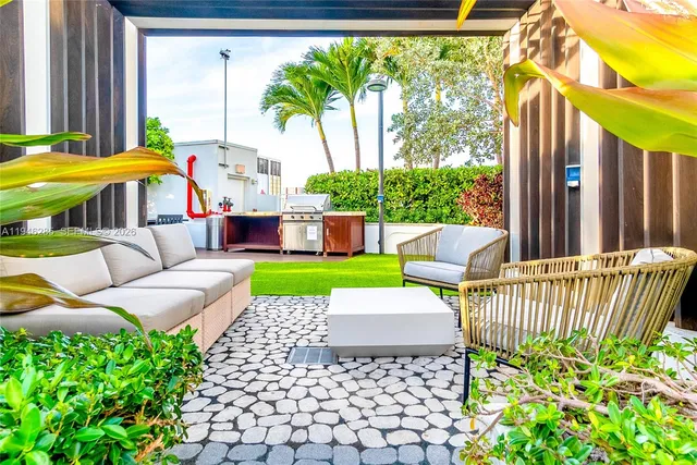 a view of a patio with couches table and chairs and potted plants