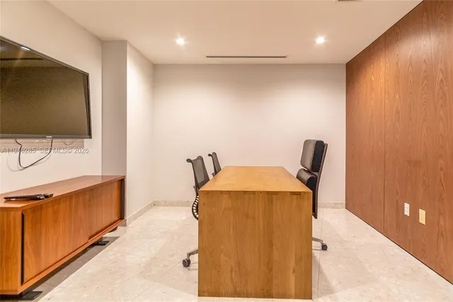 a en suite bathroom with a granite countertop sink and a mirror