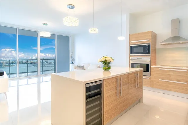 a kitchen that has a sink and a stove in it