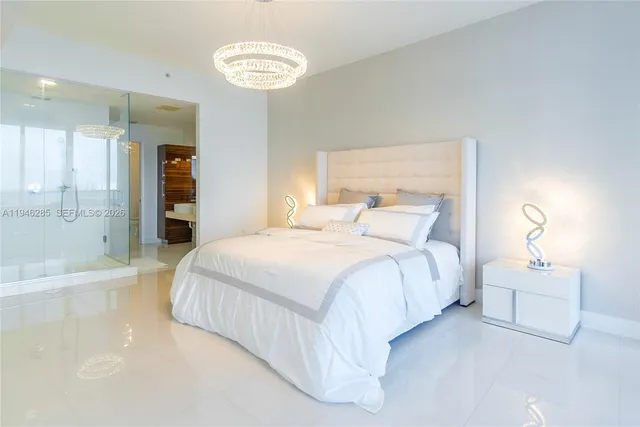a bedroom with a bed and a chandelier