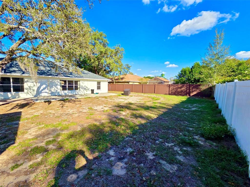 10154 Henderson Street Spring Hill, FL 34608 - Photo 18 of 19 a view of a house with a yard