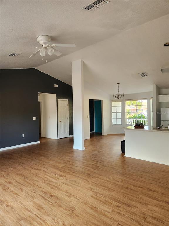 10154 Henderson Street Spring Hill, FL 34608 - Photo 2 of 19 a view of an empty room with window and wooden floor