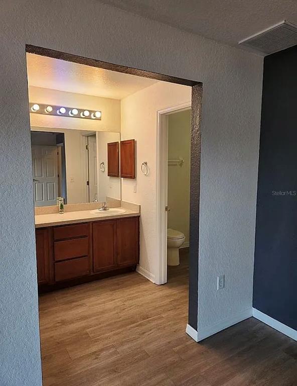 10154 Henderson Street Spring Hill, FL 34608 - Photo 7 of 19 a bathroom with a double vanity sink and mirror