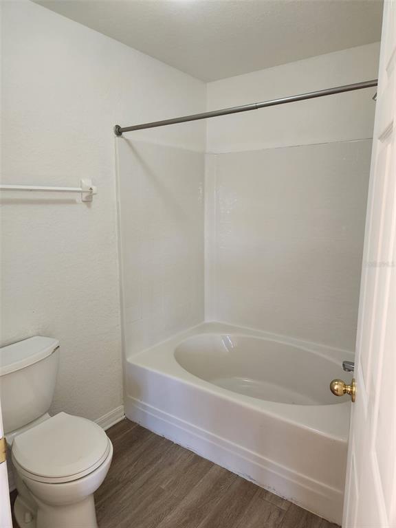 10154 Henderson Street Spring Hill, FL 34608 - Photo 10 of 19 a white bath tub sitting next to a toilet