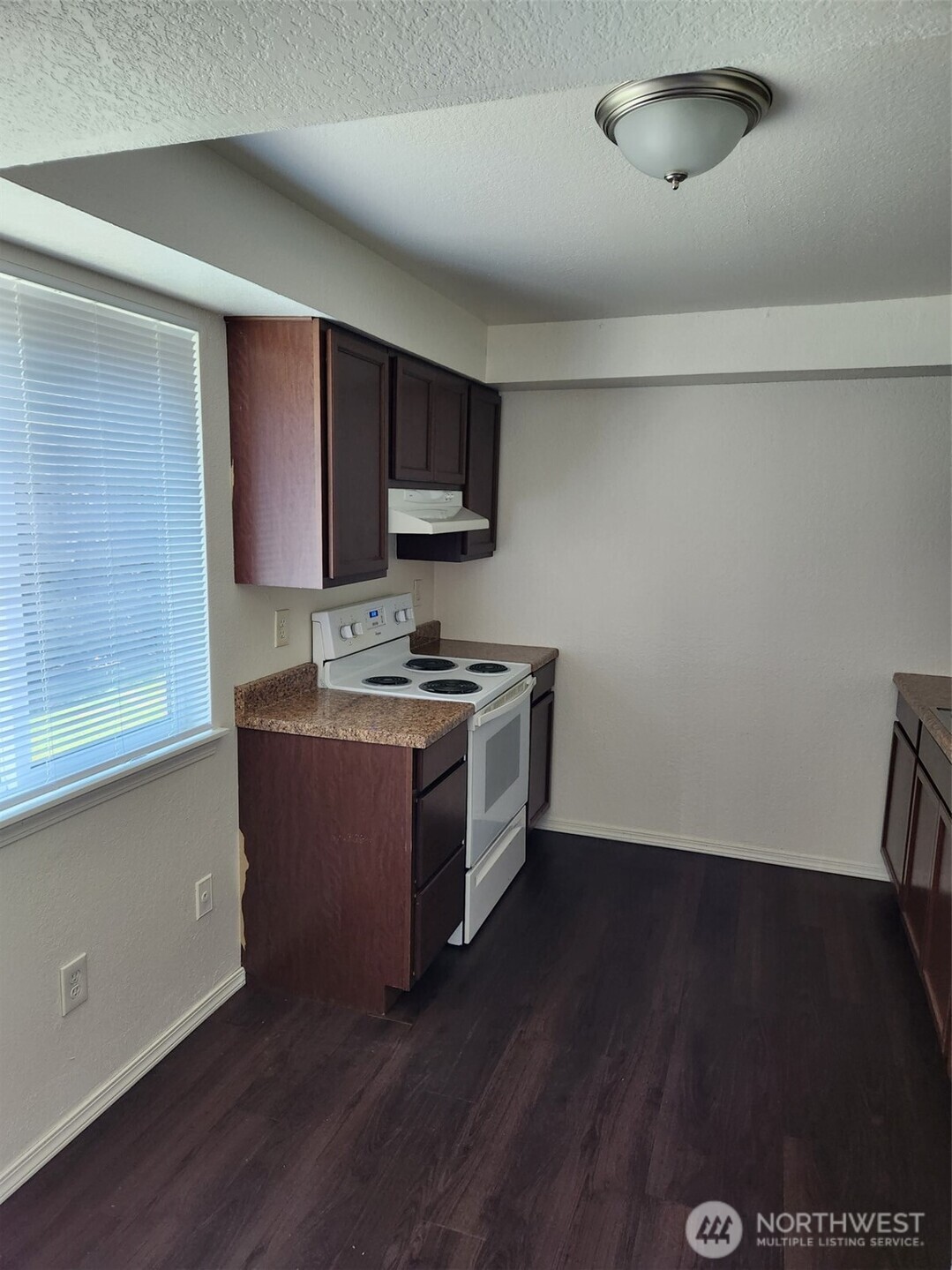 218 3rd Avenue Southwest Pacific, WA 98047 - Photo 11 of 16 a kitchen with a sink a microwave a stove and cabinets