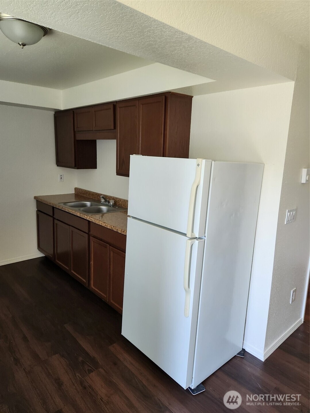 218 3rd Avenue Southwest Pacific, WA 98047 - Photo 12 of 16 a white refrigerator freezer sitting in a kitchen