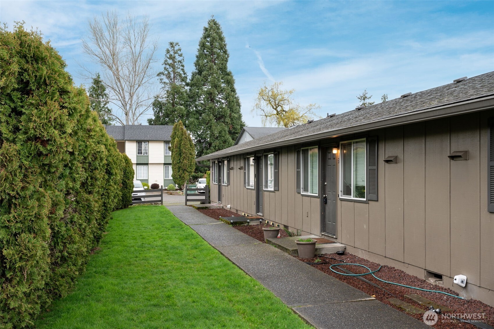 218 3rd Avenue Southwest Pacific, WA 98047 - Photo 5 of 16 a backyard of a house with table and chairs