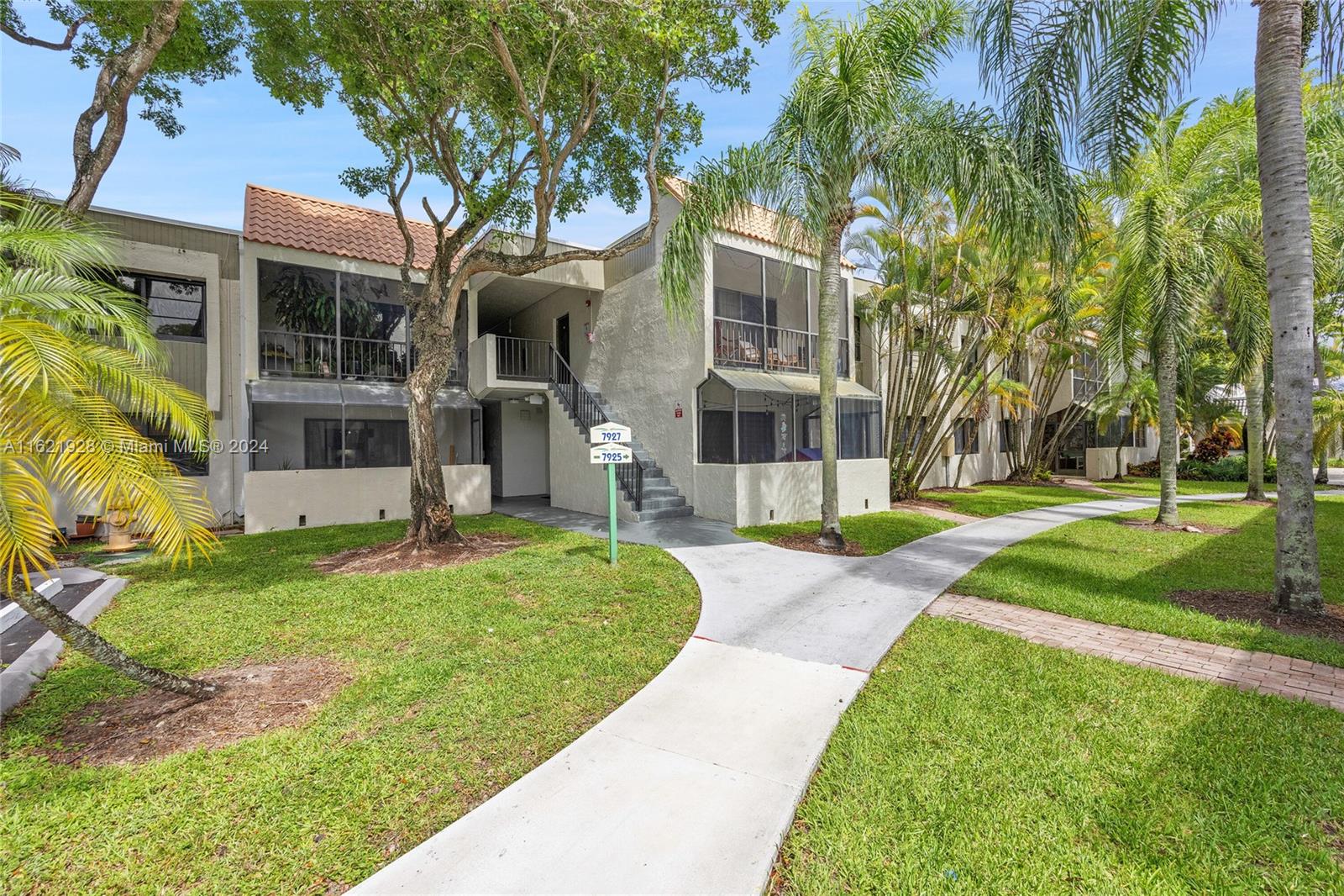 7927 Southwest 104th Street, Unit 108E Miami, FL 33156 - Photo 11 of 17 front view of a house with a yard