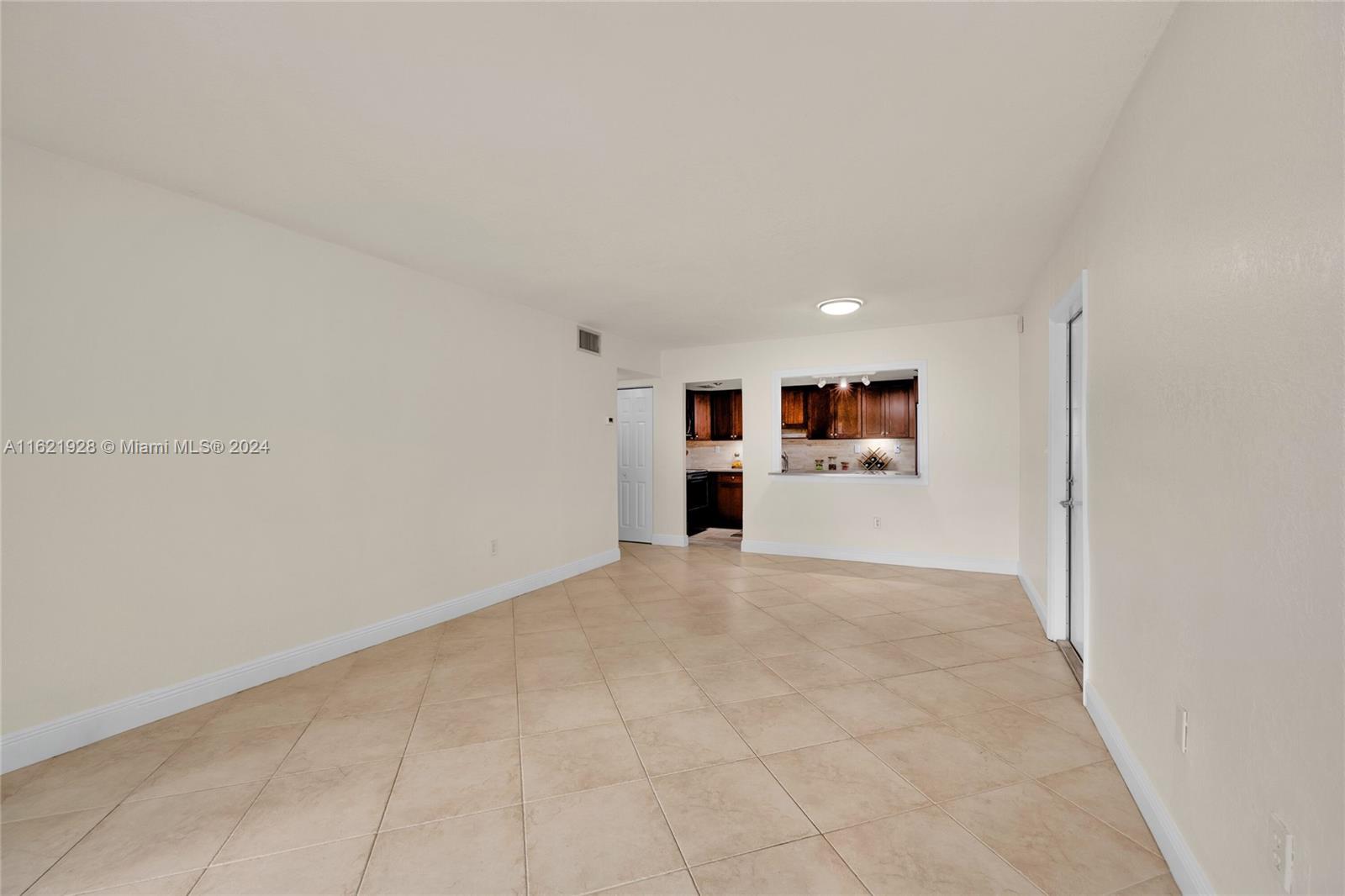 7927 Southwest 104th Street, Unit 108E Miami, FL 33156 - Photo 15 of 17 a big room with closet and windows