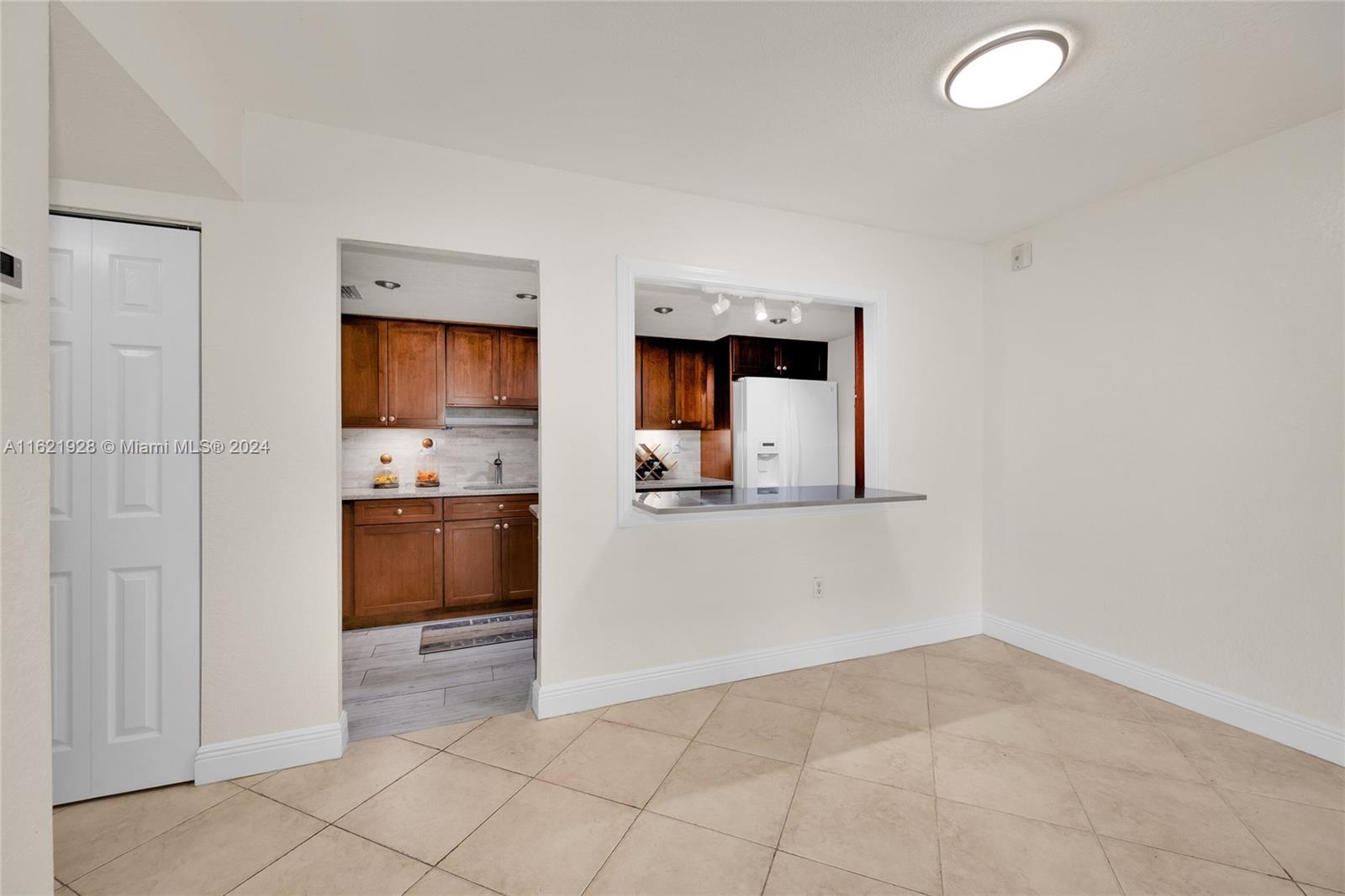 7927 Southwest 104th Street, Unit 108E Miami, FL 33156 - Photo 16 of 17 a view of kitchen with sink and refrigerator