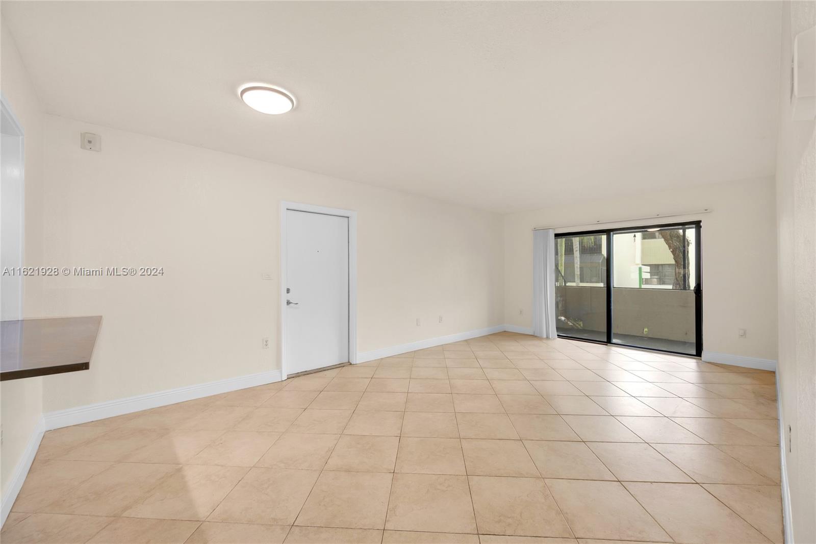 7927 Southwest 104th Street, Unit 108E Miami, FL 33156 - Photo 6 of 17 a view of an empty room with glass door