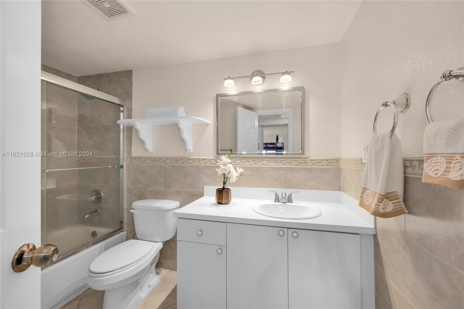 7927 Southwest 104th Street, Unit 108E Miami, FL 33156 - Photo 8 of 17 a bathroom with a sink toilet and shower