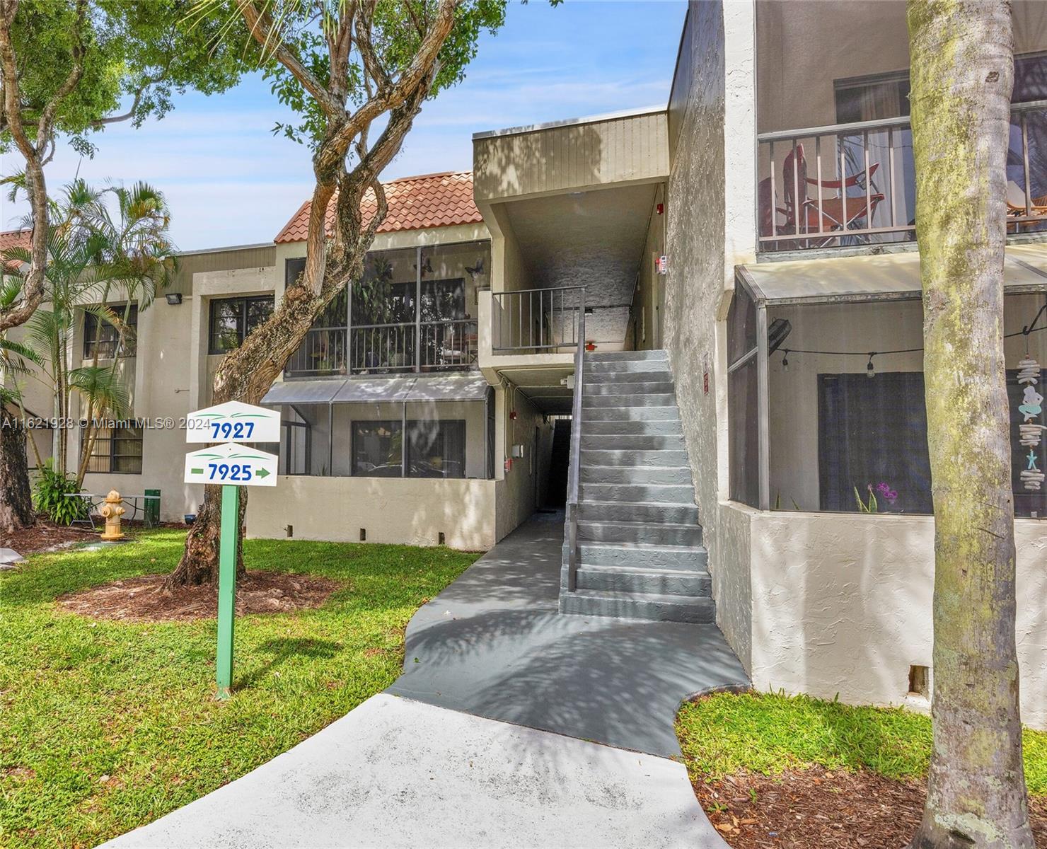 7927 Southwest 104th Street, Unit 108E Miami, FL 33156 - Photo 10 of 17 a front view of a house with garden