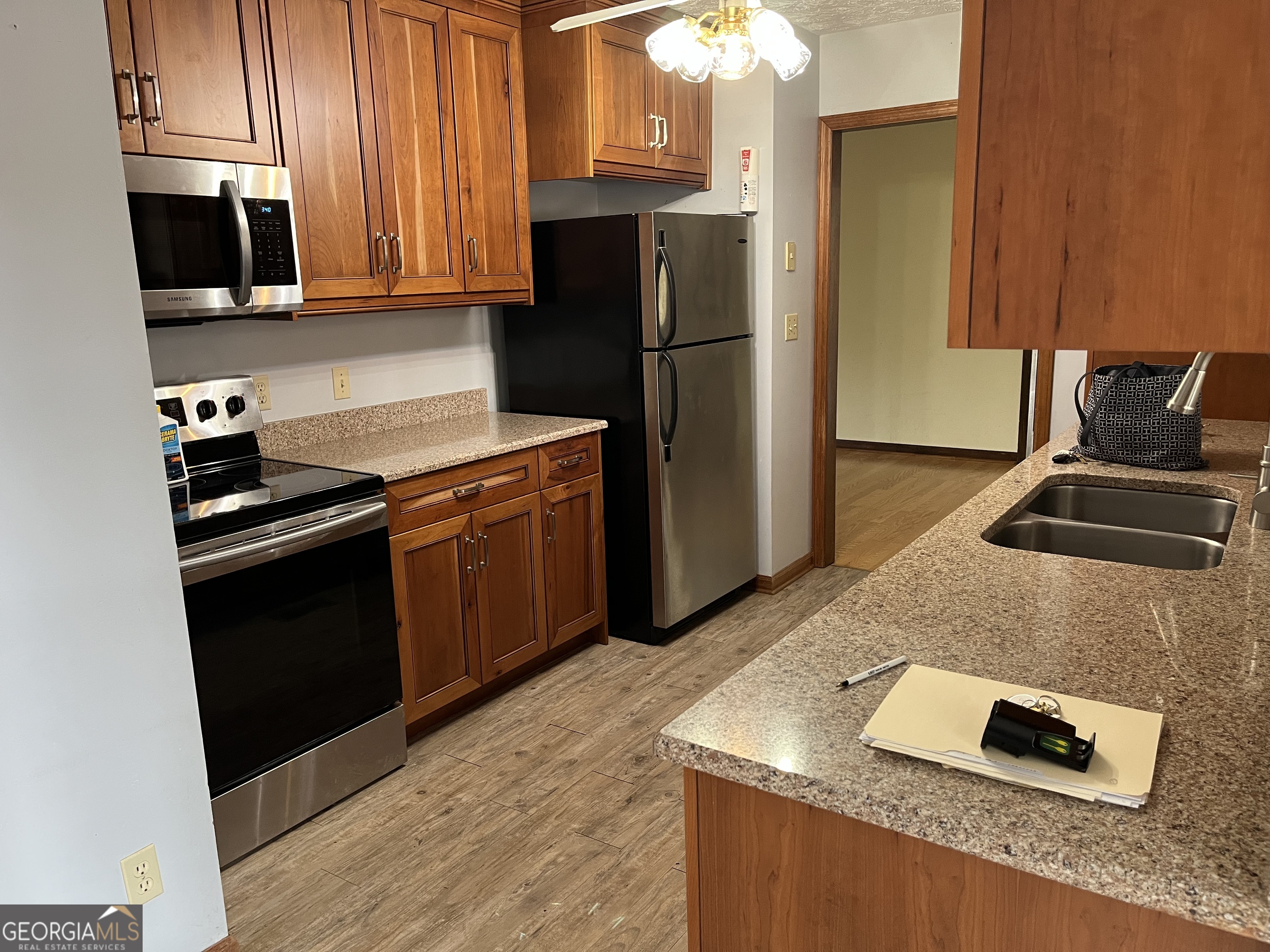 475 Davis Road Southwest Cave Spring, GA 30124 - Photo 8 of 27 a kitchen with granite countertop a stove and a refrigerator