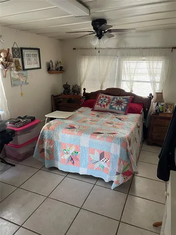 a bedroom with a bed and a mirror