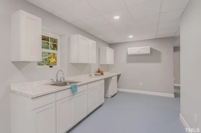 a kitchen with a sink cabinets and window