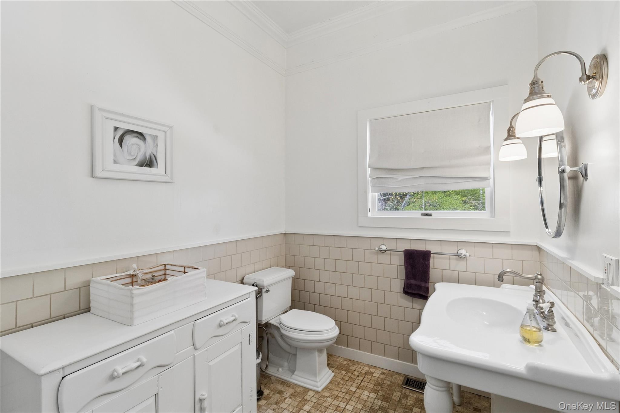 91 Sunset Beach Road Sag Harbor, NY 11963 - Photo 11 of 16 a bathroom with a toilet sink and mirror