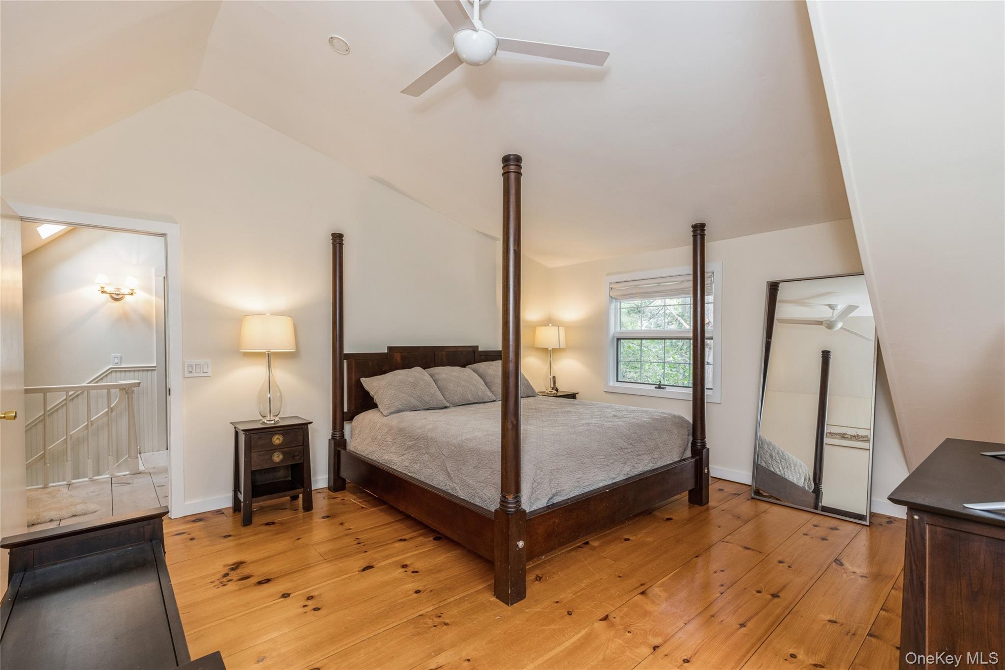 91 Sunset Beach Road Sag Harbor, NY 11963 - Photo 13 of 16 a bedroom with a bed and a dresser with wooden floor