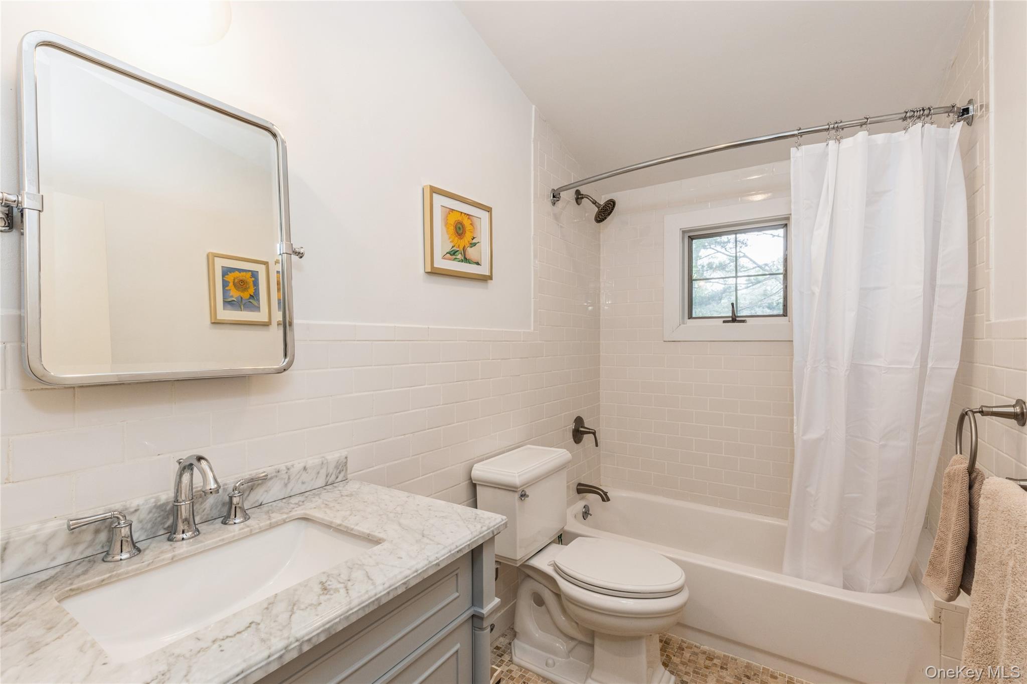91 Sunset Beach Road Sag Harbor, NY 11963 - Photo 14 of 16 a bathroom with a granite countertop sink toilet and a mirror