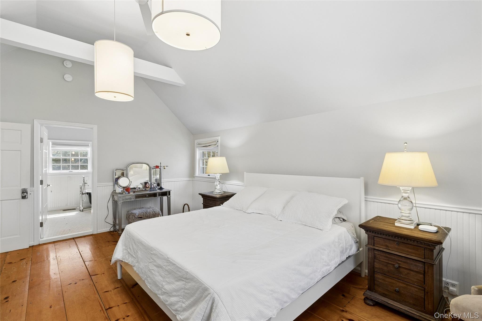 91 Sunset Beach Road Sag Harbor, NY 11963 - Photo 6 of 16 a bedroom with a bed and wooden floor