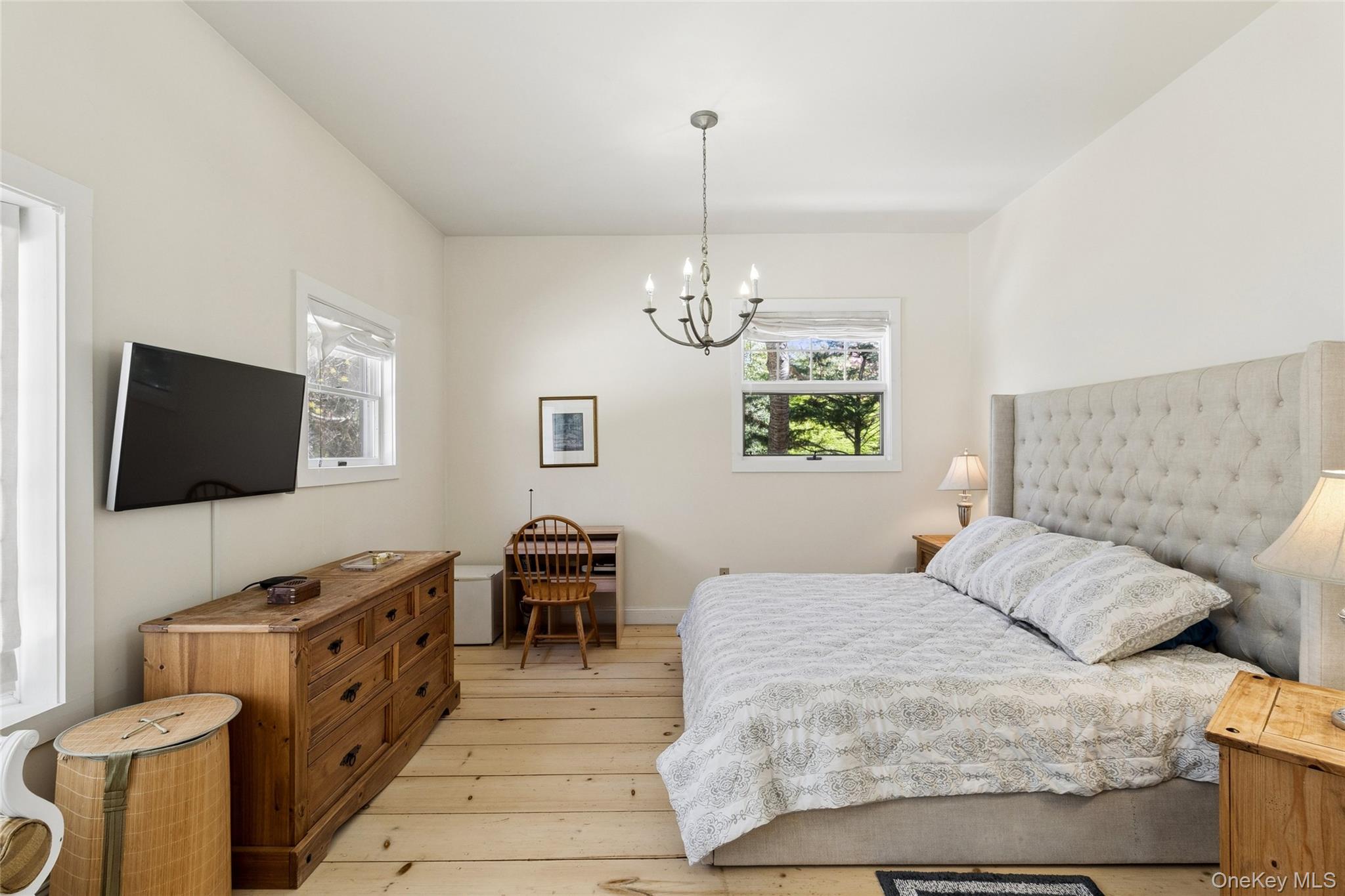 91 Sunset Beach Road Sag Harbor, NY 11963 - Photo 9 of 16 a spacious bedroom with a bed and a flat screen tv