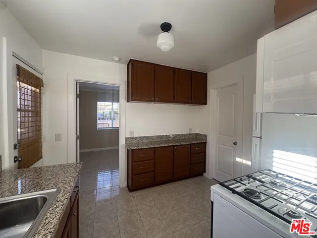 a kitchen with stainless steel appliances granite countertop a stove and a sink