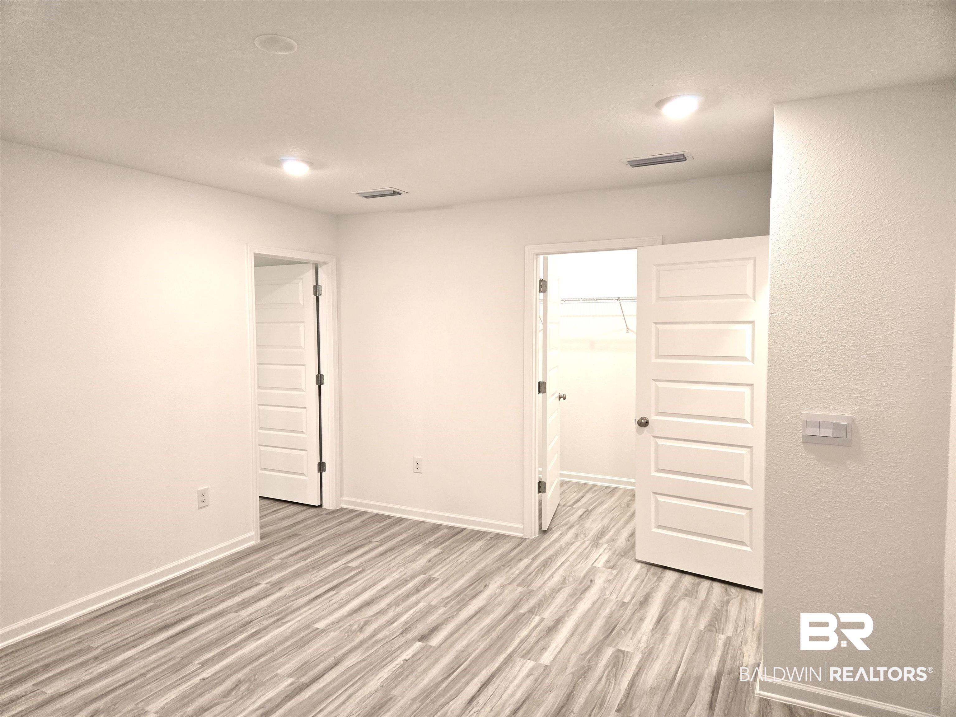 24385 Ringneck Loop Elberta, AL 36530 - Photo 15 of 33 Spare room featuring light wood-type flooring