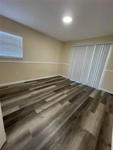 a view of a room with wooden floor