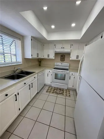 a kitchen with a stove a sink and a microwave