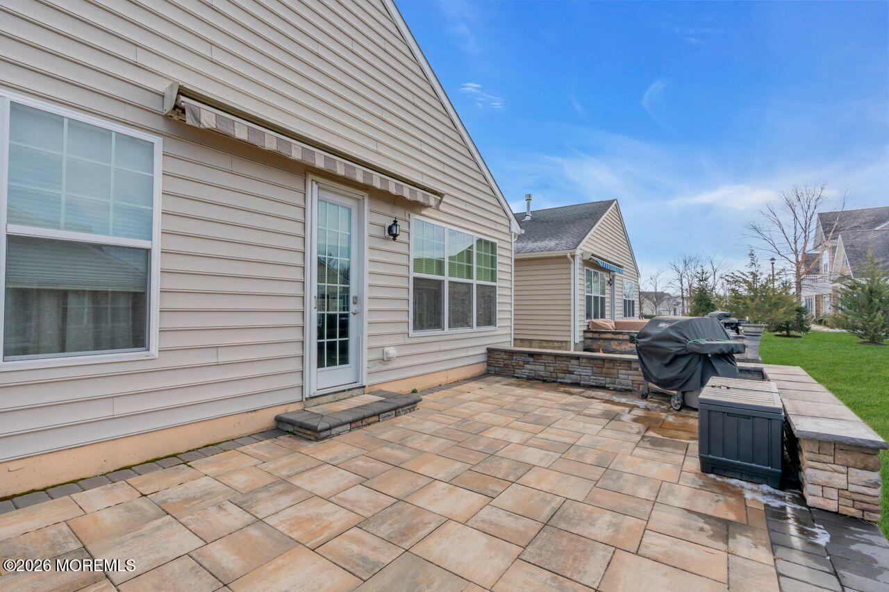 30 Harvest Ridge Road Howell, NJ 07731 - Photo 31 of 38 a view of a patio with table and chairs and wooden fence