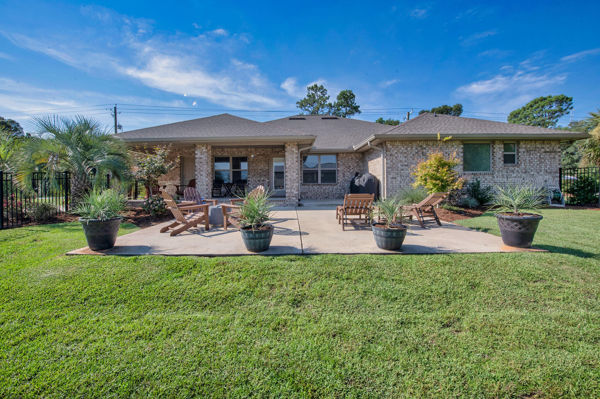 5392 South A Jones Road Milton, FL 32583 - Photo 12 of 55 a view of a patio with table and chairs potted plants and large tree