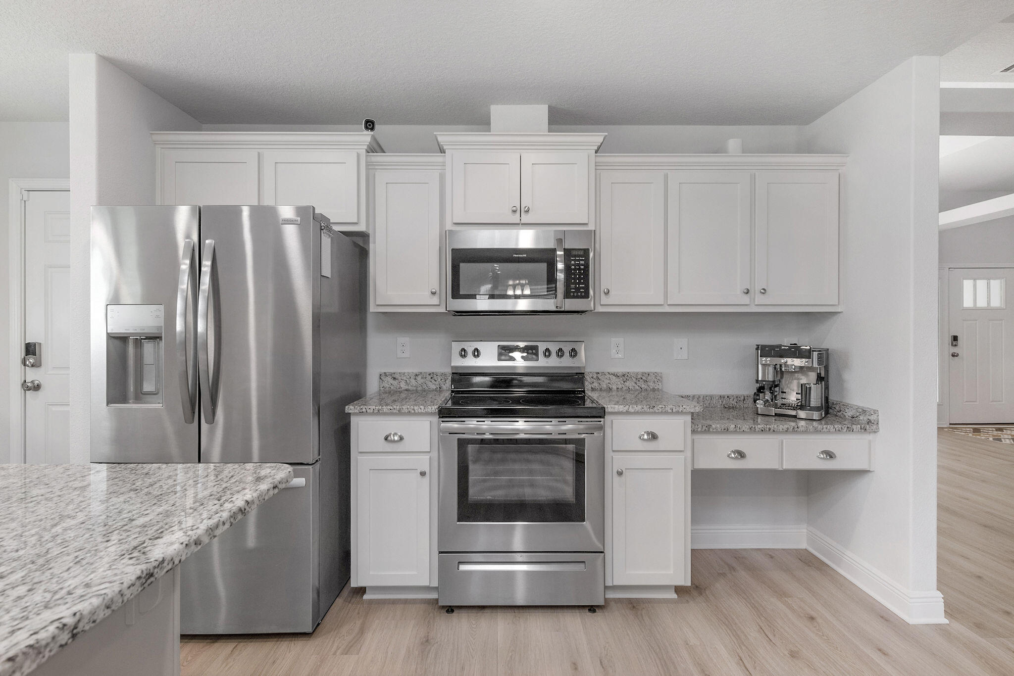 5392 South A Jones Road Milton, FL 32583 - Photo 22 of 55 a kitchen with stainless steel appliances granite countertop a stove a refrigerator and a white cabinets