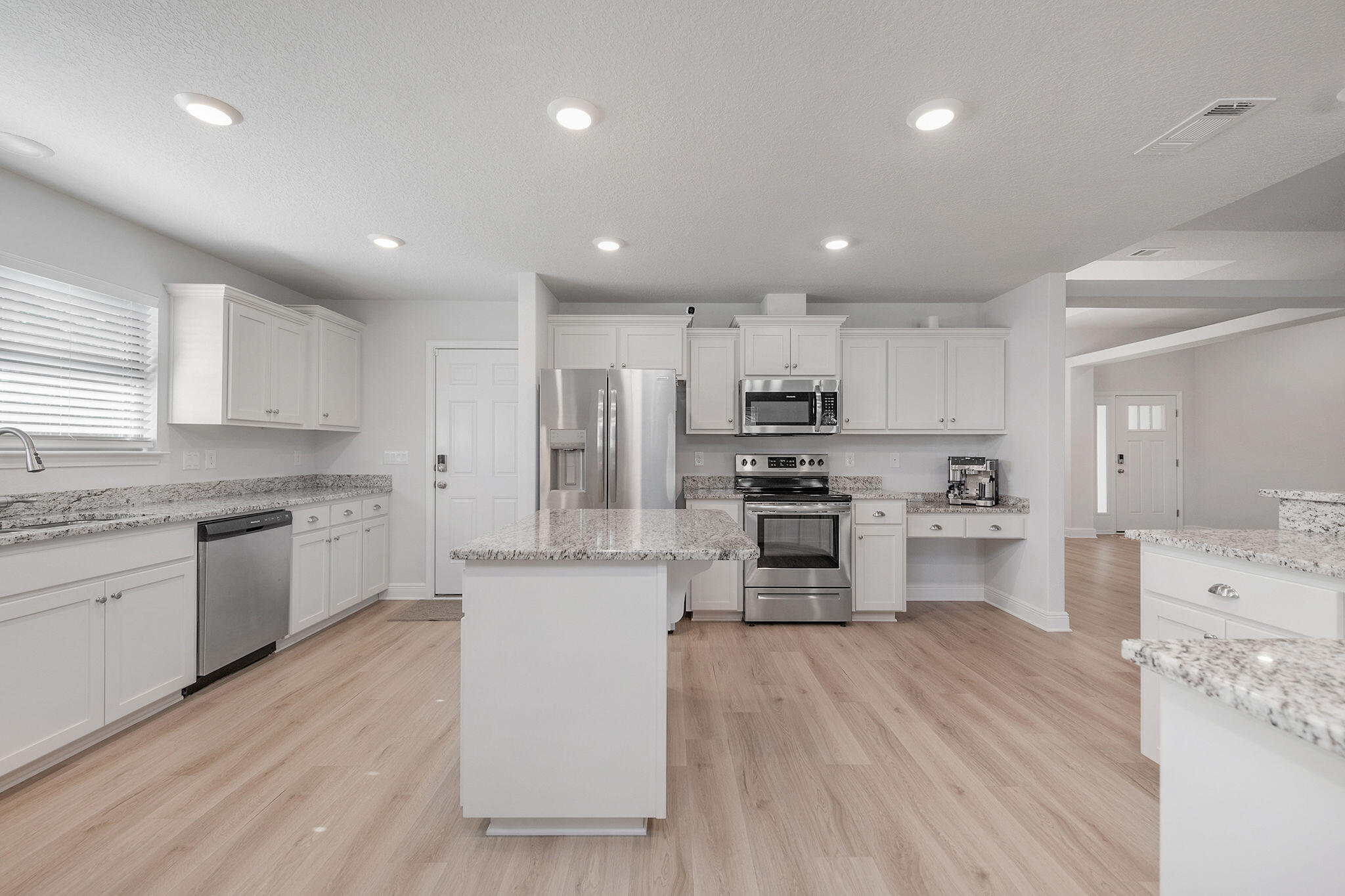 5392 South A Jones Road Milton, FL 32583 - Photo 23 of 55 a kitchen with stainless steel appliances a refrigerator sink cabinets and wooden floor