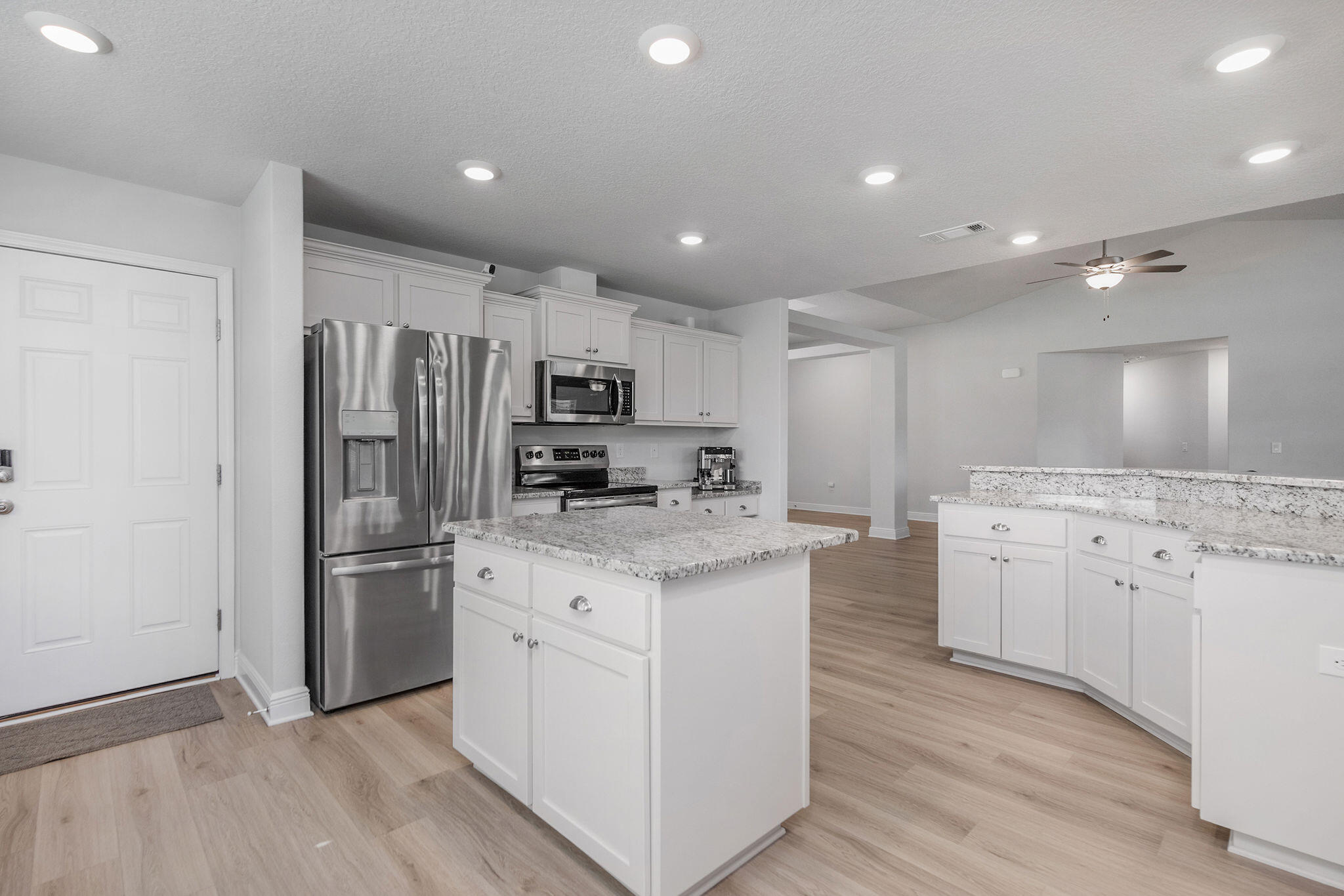 5392 South A Jones Road Milton, FL 32583 - Photo 24 of 55 a kitchen with kitchen island white cabinets and stainless steel appliances