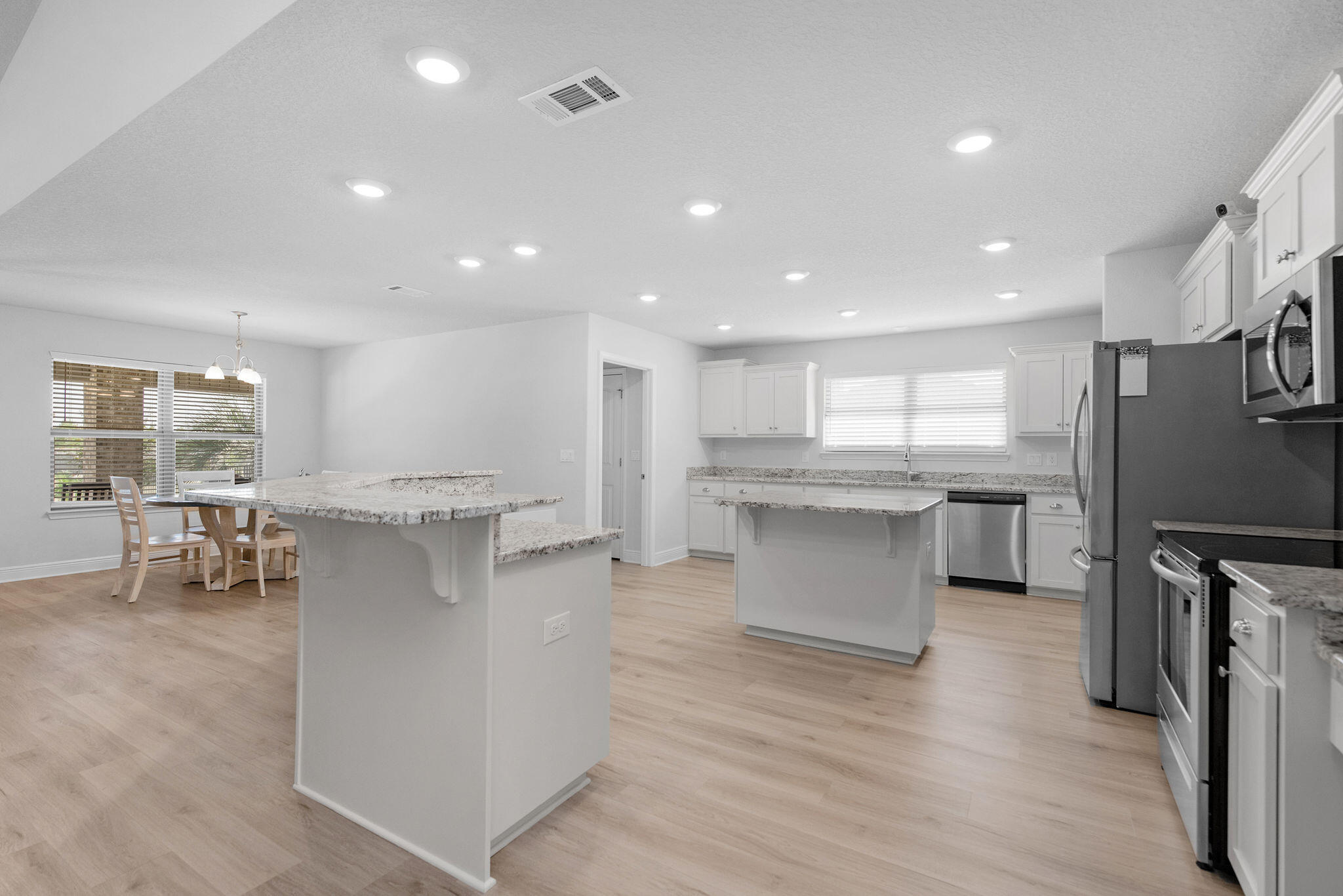 5392 South A Jones Road Milton, FL 32583 - Photo 28 of 55 an open kitchen with kitchen island white cabinets and stainless steel appliances