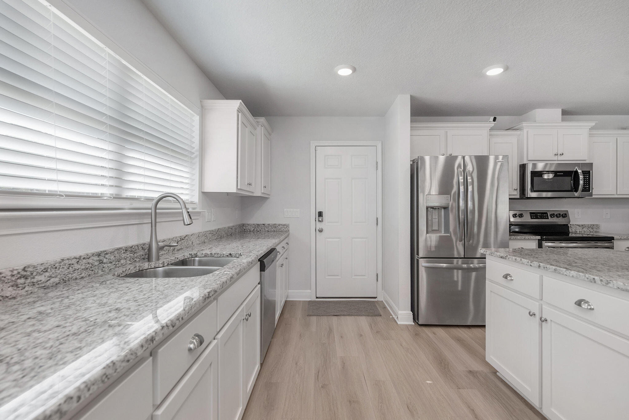 5392 South A Jones Road Milton, FL 32583 - Photo 30 of 55 a kitchen with granite countertop a refrigerator stove and sink