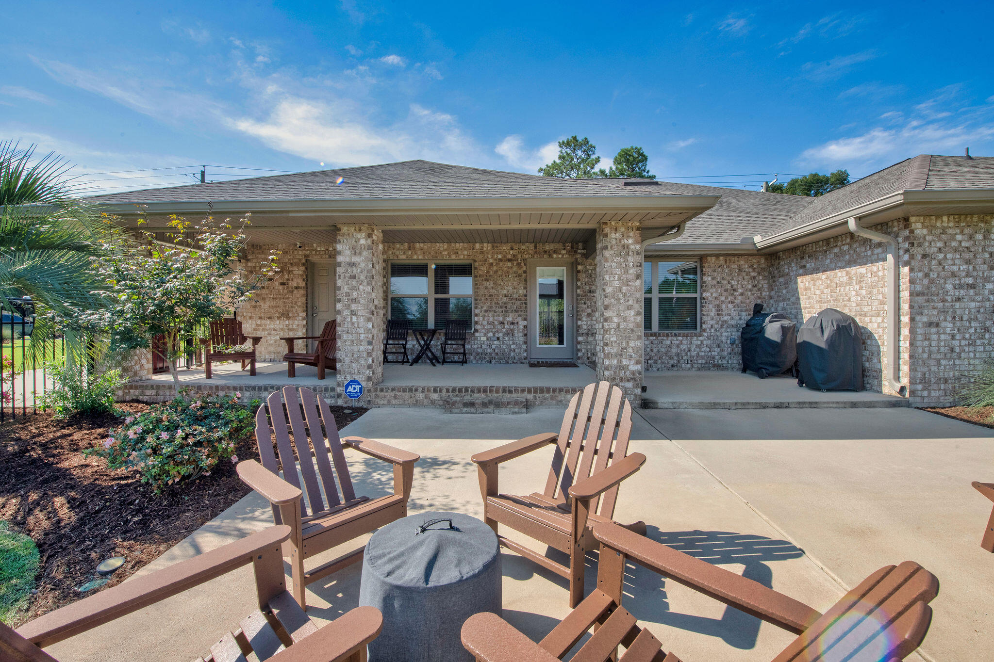 5392 South A Jones Road Milton, FL 32583 - Photo 5 of 55 a view of a patio with table and chairs potted plants and a large tree