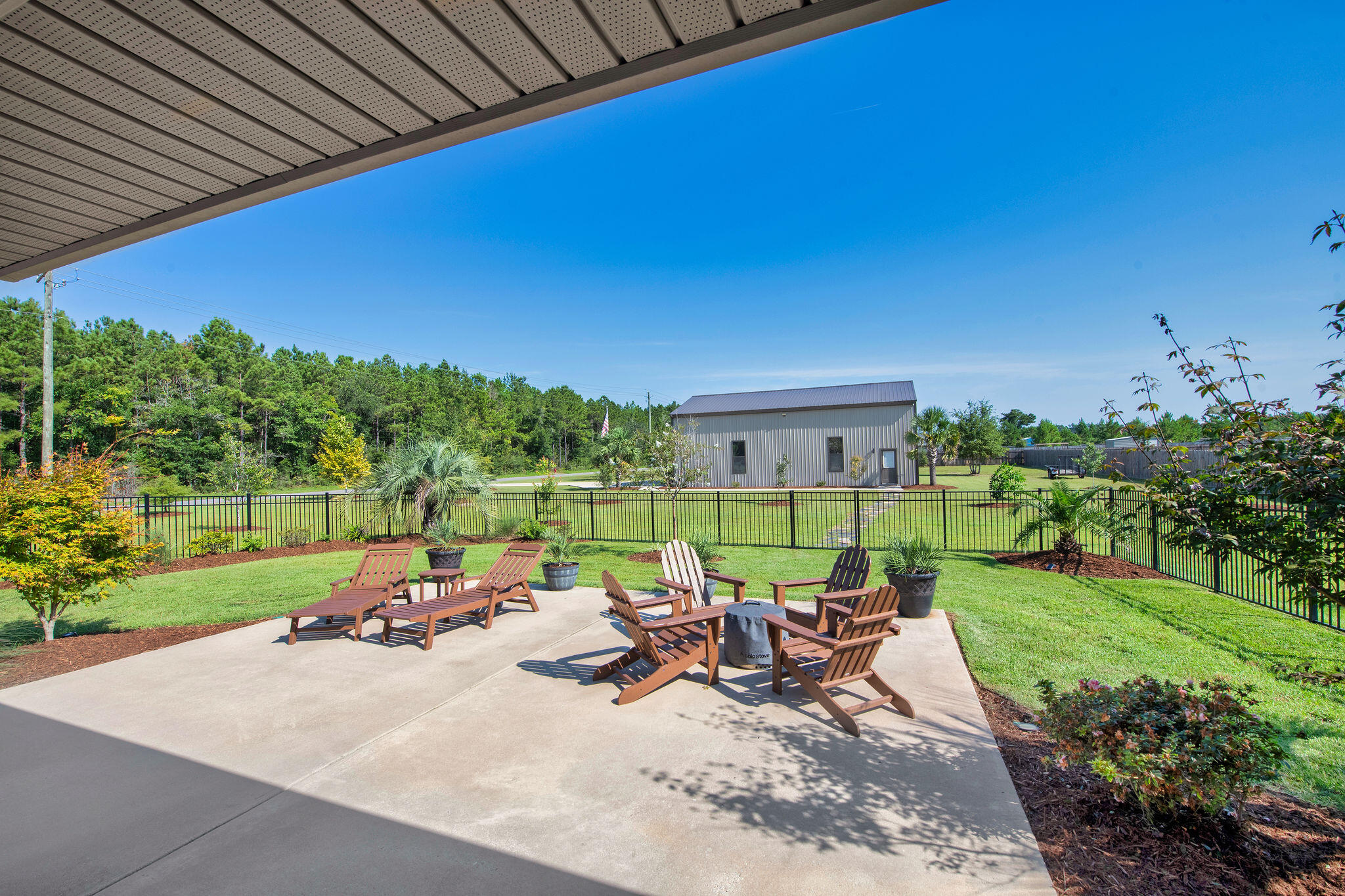 5392 South A Jones Road Milton, FL 32583 - Photo 8 of 55 a view of a patio with a table chairs and a backyard